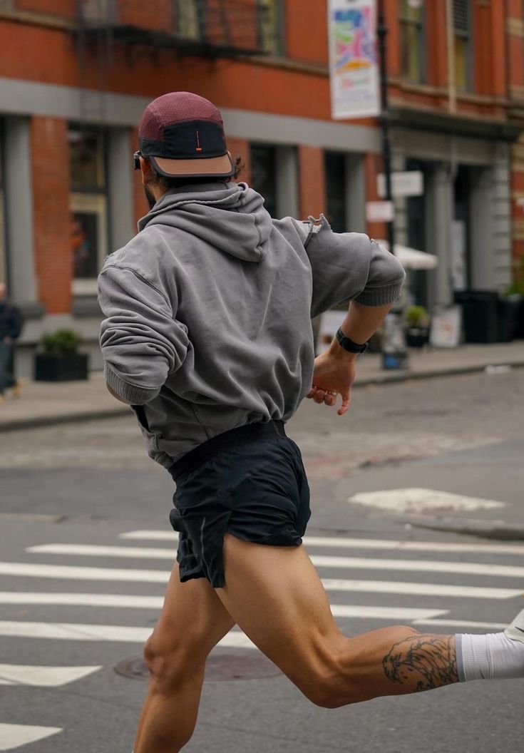 Runner crossing a city street at pace