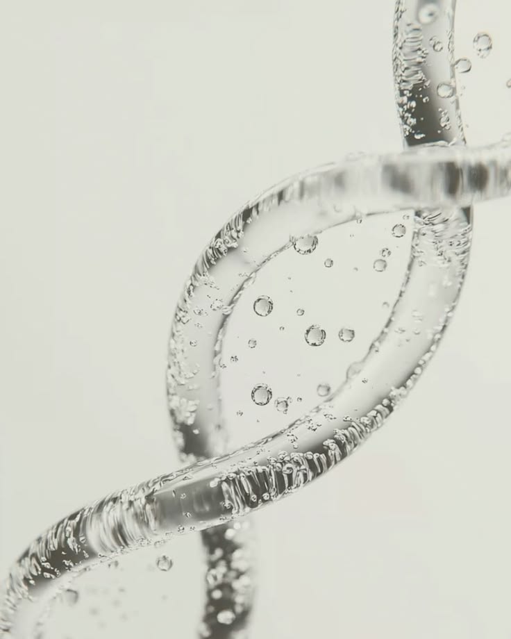 Close-up of a clear peptide serum double-helix strand